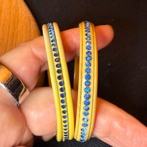 Two antique 1920s - 1930s celluloid and blue rhinestone bangles